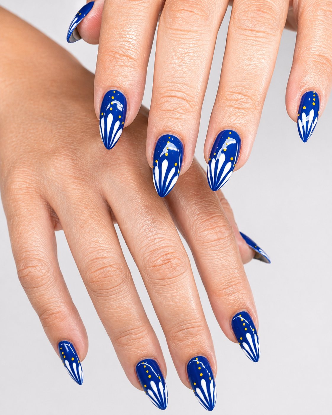 Royal blue nails with white floral burst design by Vannie