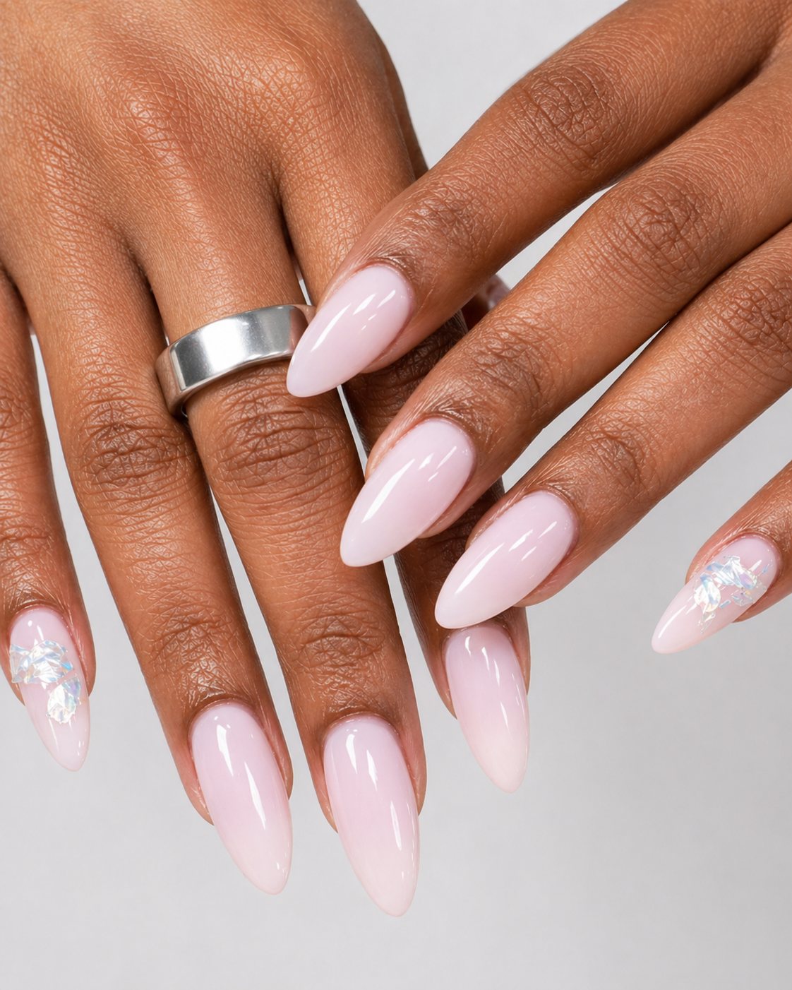 Soft milky pink almond nails with iridescent accent by Vannie